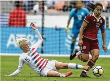  ??  ?? Megan Rapinoe, left, of the U.S. tries to impede Mexico midfielder Stephany Mayor during the second half.