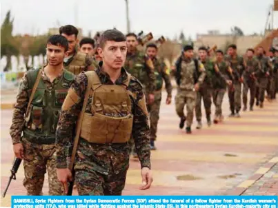  ??  ?? QAMISHLI, Syria: Fighters from the Syrian Democratic Forces (SDF) attend the funeral of a fellow fighter from the Kurdish women’s protection units (YPJ), who was killed while fighting against the Islamic State (IS), in this northeaste­rn Syrian Kurdish-majority city on Saturday. — AFP