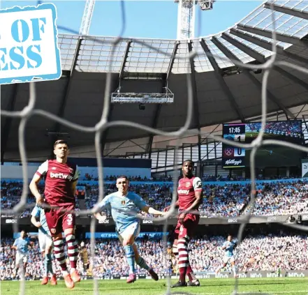  ?? ?? Net gain: Phil Foden strokes the ball beyond Alphonse Areola in the West Ham goal to give City a 2-0 lead after 18 minutes