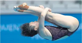  ??  ?? Chinese winner Shi Tingmao dives in the women’s 3m springboar­d final.