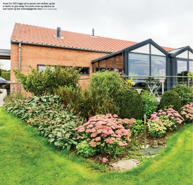  ?? Foto: Camilla Skøtt ?? Huset fra 2003 ligger på en grund, som skråner, og der er derfor en god udsigt fra husets stuer og udestue ud over haven og den omkringlig­gende natur.