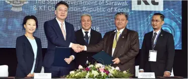  ??  ?? Morshidi (second right) and Kim (second left) exchange the signed MoUs, while witnessed by Awang Tengah (centre), Zaidi (right) and Shin. — Photo by Tan Song Wei