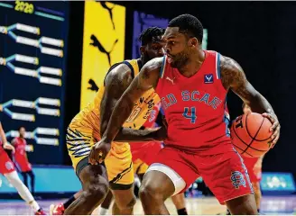  ??  ?? Trey Landers of the Red Scare dribbles against the Golden Eagles in The Basketball Tournament’s semifinals Sunday in Columbus. Landers led the UD alumni team with 21 points.