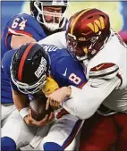  ?? John McDonnell / The Washington Post ?? Commanders defensive tackle Daron Payne sacks Giants quarterbac­k Daniel Jones in overtime.