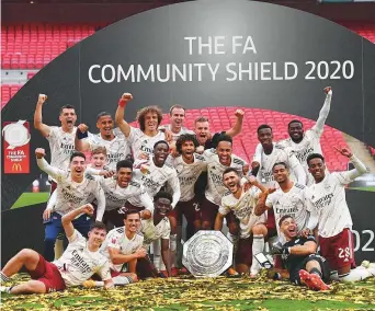  ?? Reuters ?? Arsenal players celebrate with the trophy after winning the FA Community Shield at the Wembley Stadium in London yesterday.