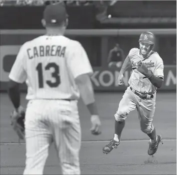  ?? Julie Jacobson Associated Press ?? CHRIS TAYLOR HEADS FOR THIRD on a single by Corey Seager in the fifth inning. Taylor, who led off the game with a home run, scored on a double-play grounder by Justin Turner to give the Dodgers a 3-0 lead.