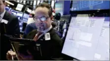  ?? RICHARD DREW — THE ASSOCIATED PRESS ?? Trader Robert Arciero works on the floor of the New York Stock Exchange, Friday.