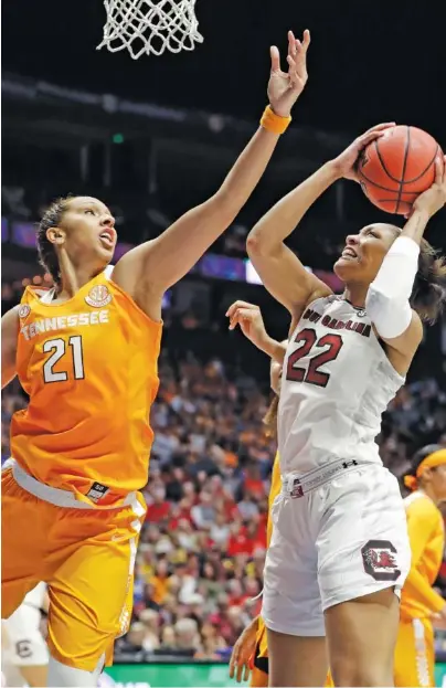  ?? THE ASSOCIATED PRESS ?? South Carolina forward A’ja Wilson (22) shoots over Tennessee center Mercedes Russell (21) in the second half of their SEC tournament game Friday night in Nashville. Wilson scored 24 points as the Gamecocks won 73-62.