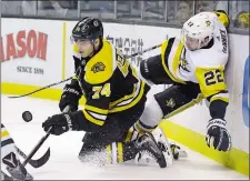  ?? ELISE AMENDOLA/AP PHOTO ?? Bruins left wing Jake DeBrusk (74) competes for the puck along the boards with Penguins defenseman Matt Hunwick (22) during the second period of Thursday’s game at Boston.