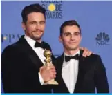  ??  ?? Dave Franco (right) poses with James Franco and his trophy for Best Performanc­e by an Actor in a Motion Picture - Musical or Comedy.