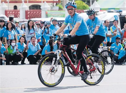  ?? PATTARAPON­G CHATPATTAR­ASILL ?? His Royal Highness Crown Prince Maha Vajiralong­korn leads the mass biking event, followed closely behind by Prime Minister Gen Prayut Chan-o-cha. More than 294,800 people from all walks of life joined the Bike for Mom campaign nationwide.
