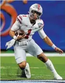  ?? GERALD HERBERT/AP ?? Ohio State quarterbac­k Justin Fields runs against Clemson during the first half of the Sugar Bowl on Friday in New Orleans.