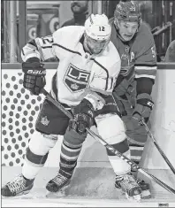  ?? CP PHOTO ?? Los Angeles Kings’ Marian Gaborik and Carolina Hurricanes’ Jeff Skinner battle for the puck during an NHL game Tuesday night in Raleigh, N.C.