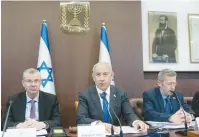  ?? (Yonatan Sindel/Flash90) ?? PRIME MINISTER Benjamin Netanyahu chairs the cabinet meeting yesterday, flanked by Justice Minister Yariv Levin (left) and Cabinet Secretary Yossi Fuchs.