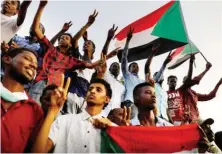  ?? Sudanese make victory signs as they protest in Khartoum. ??