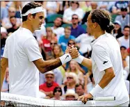  ?? AP/ALASTAIR GRANT ?? Alexandr Dolgopolov (right) greets Roger Federer at the net after Dolgopolov was forced to quit their first-round Wimbledon match in the second set Tuesday because of a right ankle injury. Federer was leading 6-3, 3-0 before Dolgopolov retired.