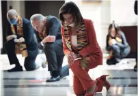  ?? BRENDAN SMIALOWSKI AFP/GETTY IMAGES ?? Democratic lawmakers, including U.S. House Speaker Nancy Pelosi, observe a moment of silence on Capitol Hill on Monday.