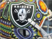  ?? Erik Verduzco ?? Las Vegas Review-journal) @Erik_verduzco The Raiders Preview Center displays team memorabili­a, including a Huichol art decorated helmet.