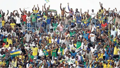  ?? AP ?? In this Monday, January 23, 2012 file photo, Gabon fans celebrate after their national team scored against Niger in their African Cup of Nations Group C match at Stade De L’Amitie in Libreville, Gabon. The African Cup of Nations returns to Gabon for...