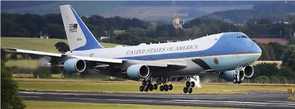  ??  ?? Flying in: Air Force One touches down at Prestwick with the US President and First Lady aboard