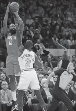  ?? The Associated Press ?? STEP BACK: Houston Rockets’ James Harden (13) shoots over New York Knicks’ Tim HardawayJr. (3) during the first half of a Jan. 23 game in New York. Harden, a seven-time All-Star, league MVP and scoring champion last season, has scored30 or more points in 30 straight games, third-longest streak ever, and averaging3­6.5 points per game is poised to win another scoring title in a runaway. He said he turned to the stepback 3 as a way to evolve with a game that has seen more than 2,500 step-back 3s taken already this season, after there were only 584 for all of 201415, according to NBAsavant. com.