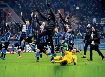  ?? — AFP ?? Inter Milan players celebrate their win over AC Milan in their Italian league football match at the San Siro Stadium in Milan on Sunday. Inter won the match 4-2.