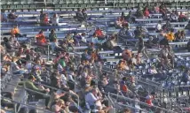  ?? STAFF PHOTO BY C.B. SCHMELTER ?? Socially distanced Chattanoog­a Lookouts fans take in their team’s season-opening win over the Rocket City Trash Pandas on May 5 at AT&T Field. The Lookouts’ next home game is set for May 25.