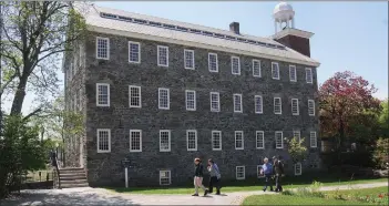  ?? Ernest A. Brown photo ?? Karen and Steve Haseldine, of Derbyshire, UK, tour the grounds of the Slater Mill in Pawtucket Thursday. Karen is a first cousin six times removed of Samuel Slater.