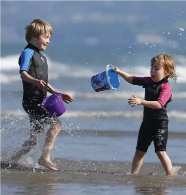  ??  ?? Clockwise from main: Juliette Orr (3) and her brother Hugo (6), from Portmarnoc­k, making a splash on Portmarnoc­k Strand in Dublin yesterday; (left to right) Orlagh McGovern from Newry, Anna Gambell from Newry and Ellen Maloney from Derry enjoying the good weather in St Stephen’s Green, Dublin; and Chloe O’Brien (10) and her brother Alan (8) from Kilbarrack with their Jack Russell pups on Dollymount beach. Photos: Damien Eagers and Gareth Chaney