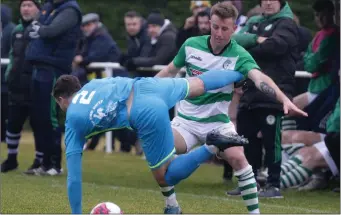  ??  ?? Craig McCabe of North End United takes a tumble as John O’Connor (Shamrock Rovers) challenges during the Premier Division clash in Hollygrove on Sunday which the home side came from behind to win 3-2.