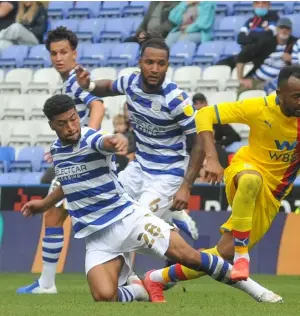  ??  ?? Reading midfielder Josh Laurent slides in to take the ball away from Crystal Palace forward An