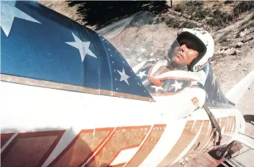  ??  ?? Evel Knievel sits in a rocket motorcycle as he prepares for his attempt to jump Idaho’s Snake River Canyon in 1974. Travis Pastrana grew up admiring Knievel’s stunts.