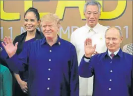  ?? AFP ?? Donald Trump and Vladimir Putin pose for a group photo with other APEC Summit leaders.