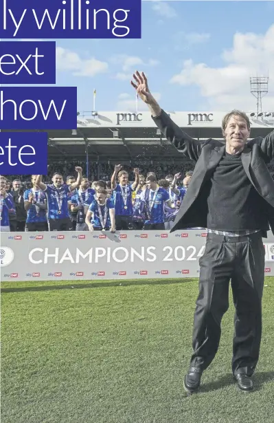  ?? ?? Pompey director Eric Eisner and skipper Marlon Pack lift the League One trophy in front of the Fratton End