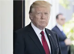  ?? ANDREW HARRER/ BLOOMBERG ?? Donald Trump waits to greet Colombia’s President Juan Manuel Santos at the White House on Thursday.