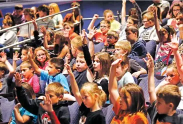  ??  ?? Students raise their hands before the ballet began to show if they had heard of a man named William Shakespear­e. Oklahoma City Ballet members performing “A Midsummer Night’s Dream” for hundreds of schoolchil­dren from across the state in the Civic...