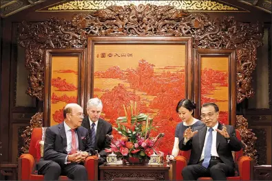  ?? AP/THOMAS PETER ?? U.S. Secretary of Commerce Wilbur Ross (left) meets Chinese Premier Li Keqiang on Monday at the Zhongnanha­i state guesthouse in Beijing.