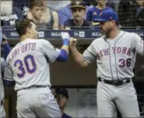  ?? MORRY GASH — THE ASSOCIATED PRESS ?? New York Mets manager Mickey Callaway congratula­tes Michael Conforto after his home run during the fourth inning of a baseball game against the Milwaukee Brewers Friday in Milwaukee.