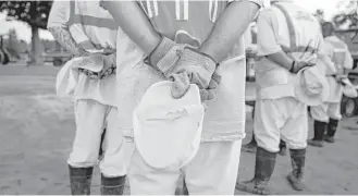  ?? Elizabeth Conley / Houston Chronicle ?? Trusties, prisoners who are close to being on parole, listen to a sermon that was given for Jack Harry Smith, who was buried Thursday at the Captain Joe Byrd Cemetery.