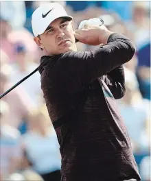  ?? SAM GREENWOOD GETTY IMAGES ?? Brooks Koepka plays his shot from the third tee during the first round of the 147th Open Championsh­ip in Carnoustie, Scotland, on Thursday. Koepka shot a 72, trailing leader Kevin Kisner by six shots.