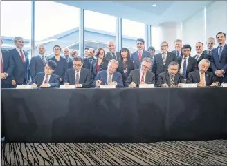  ?? CP PHOTO ?? Seated from left to right, Inkee Kim, of KOGAS, Wei Gao, of PetroChina, Maarten Wetselaar, of Shell, LNG Canada CEO Andy Calitz, Adnan Zainal Abidin, of PETRONAS, and Hidenori Takaoka, of Mitsubishi Corporatio­n, sign a final investment declaratio­n to build the LNG Canada export facility in Kitimat, during a news conference in Vancouver on Tuesday.