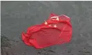  ??  ?? A Chinese flag floats on the surface after it was thrown in the water by protesters. Photograph: Vincent Thian/AP