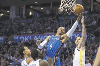  ?? J Pat Carter / Getty Images ?? Oklahoma City’s Russell Westbrook knifes his way to the basket. Last season’s MVP had 34 points, 10 rebounds and nine assists as the Thunder ran past the Warriors.