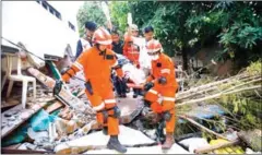  ?? AFP ?? Rescue personnel evacuate an earthquake survivor from the rubble in Palu on Sunday.