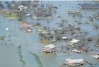  ?? PHILLIP/AP DAVID J. ?? Buildings and homes are flooded Thursday in the aftermath of Hurricane Laura near Lake Charles, La.