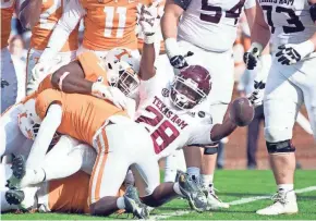  ?? BRIANNA PACIORKA/KNOXVILLE NEWS SENTINEL ?? Texas A&M running back Isaiah Spiller (28) celebrates a touchdown against Tennessee on Saturday at Neyland Stadium in Knoxville, Tenn. Spiller ran for 89 yards in the game.