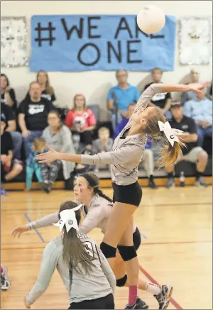  ?? Jeremy Stewart / Rome News-Tribune ?? Coosa’s Tori Overby leaps for an attack above teammates Brinley Smith and Cassie McFather (19) during the Lady Eagles’ Class AA state quarterfin­al match against Rabun County on Saturday.