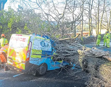 ?? ?? WRECK: A police van crushed in the storm by a fallen tree on the Dyce to Hatton of Fintray road. Picture by Kenny Elrick.