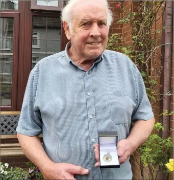  ??  ?? Hugh McGinn snr at home in Hardmans Gardens with his new Cardinal O’Donnell Cup medal, which he earned back in 1973.