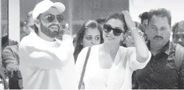  ?? AP ?? Bollywood actors Ranveer Singh (left) and Deepika Padukone arrive at airport to attend the prewedding celebratio­ns of Anant Ambani and Radhika Merchant in Jamnagar, India.